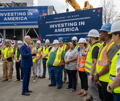 A group of workers at an Investing In America outdoor event with President Biden
