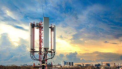 A mobile terrestrial telecommunications repeater antenna and cloudy sky in the background